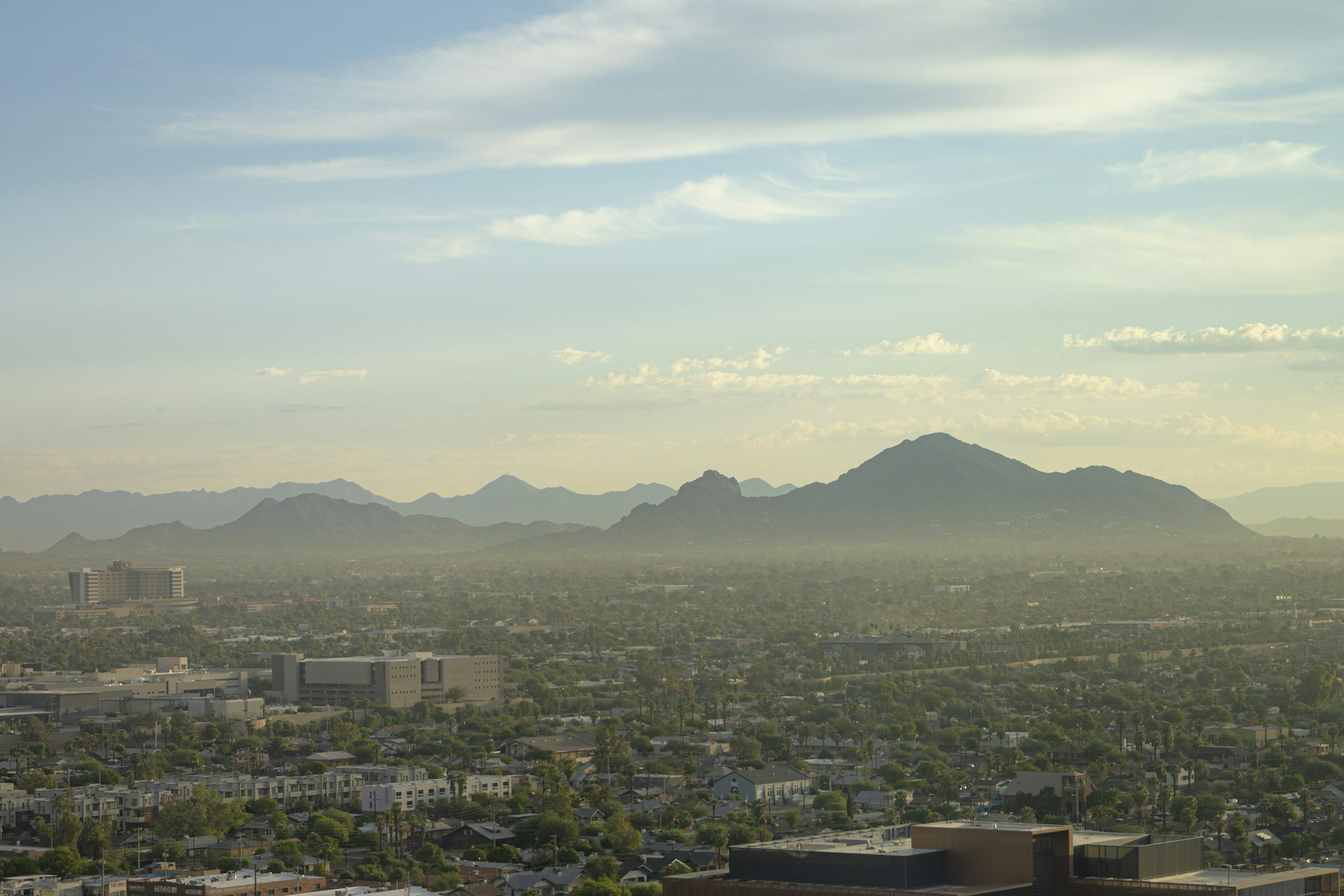 Downtown Phoenix at sunrise, with Camelback Mountain beyond the city